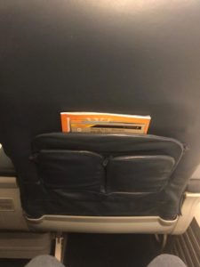 a book in a pocket of a seat