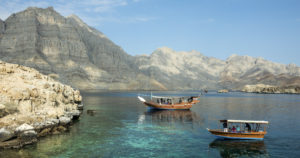 a boat in the water with mountains in the background