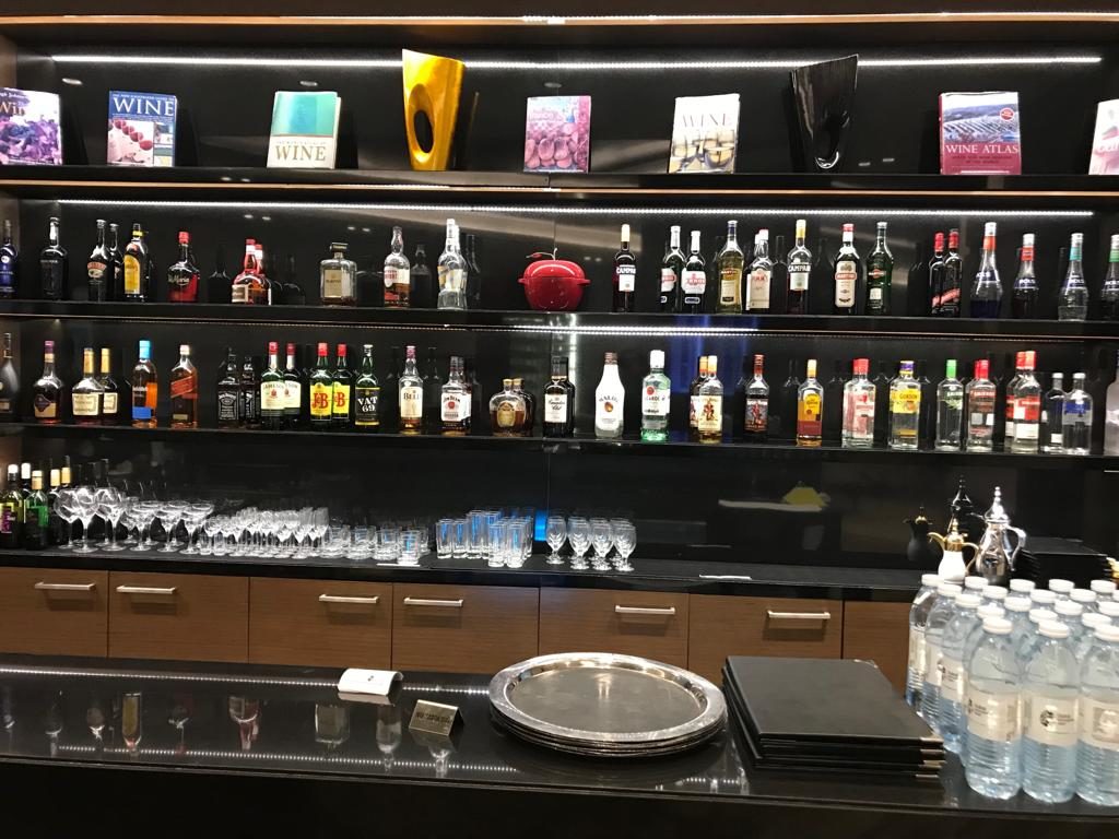 a shelf with bottles of alcohol and glasses
