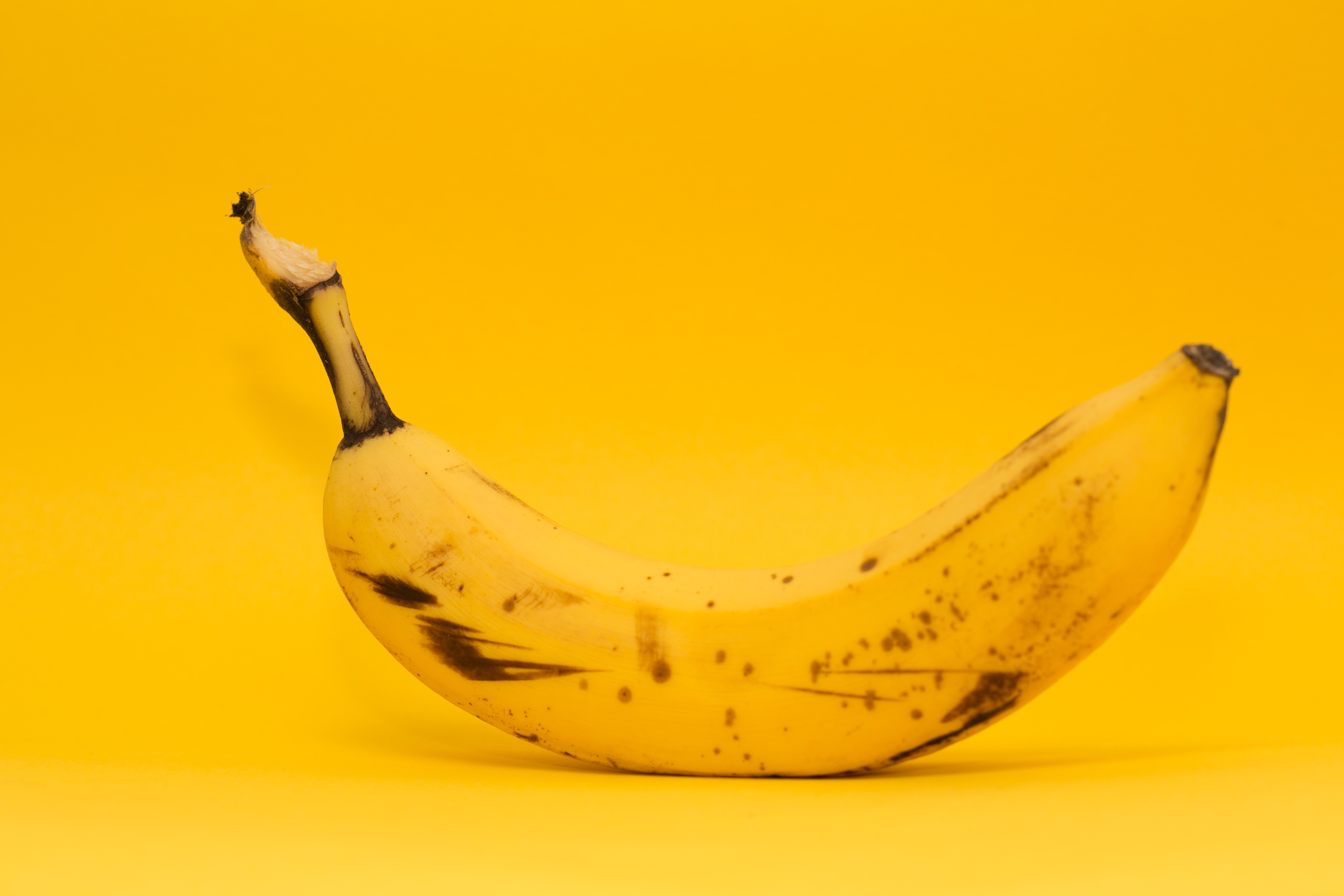 a banana with a yellow background