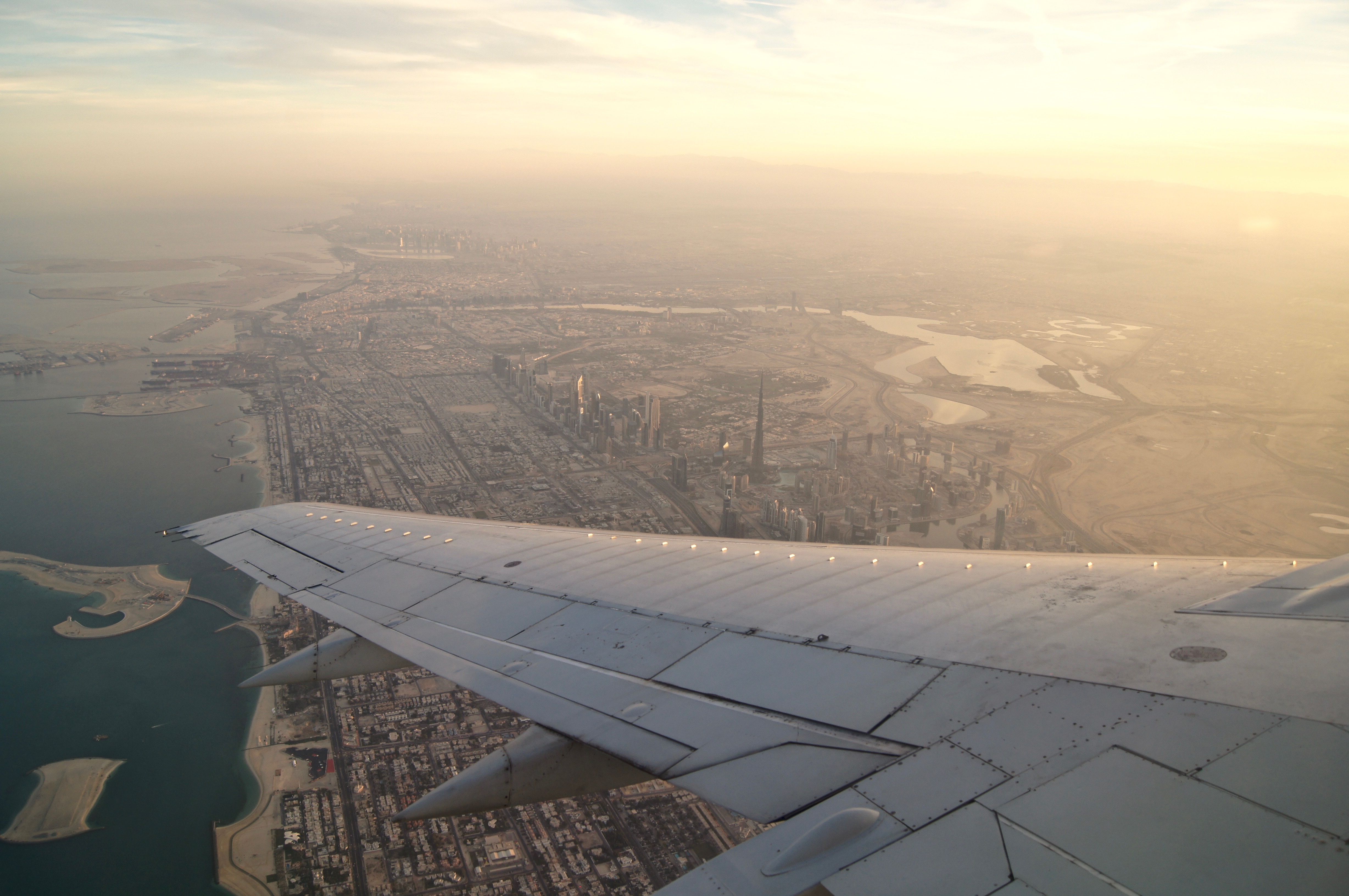 an airplane wing and city view from above